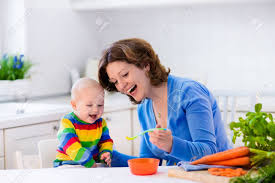 Consuming certain things creates more waste that your. Mother Feeding Child First Solid Food For Young Kid Fresh Organic Carrot For Vegetable Lunch Baby Weaning Mom And Little Boy Eat Vegetables Healthy Nutrition For Children Parents Feed Kids Stock Photo