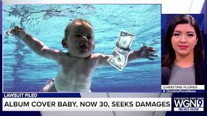 Nirvana] we have all seen the cover of nirvana's iconic album nevermind, which features a baby suspended in a swimming pool, reaching out for a dollar bill that's being dangled in front of him on a fishing line. 41zl9kcc H1y1m