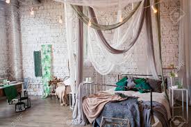 Surrounding a doorway on both sides looks balanced, and you can fit a surprising amount of clothing into a narrow space when it reaches all the way to the ceiling. Modern Loft Bedroom With High Ceiling Brick Wall Wood Floor Stock Photo Picture And Royalty Free Image Image 80128805