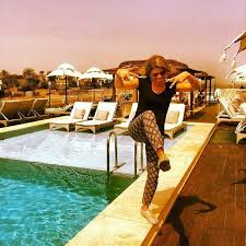 Kelley Ferro Doing A Happy Ninja Dance On A Rooftop Hotel Pool In Egypt On A Trip With Abercrombie Kent Traveltogether Hotel Pool Tourism Trip