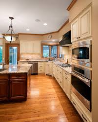 In particular, i love how the light ash is the main feature of the kitchen and appears in the doorway, kitchen island and flooring and how the white of the other kitchen cabinets is a subtle contrast. Kitchen Has White Cabinets With Dark Wood Island Side View Sattler Homes