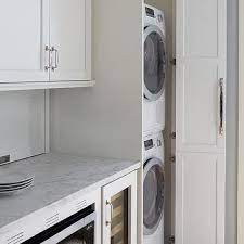 Modern laundryroom matches the rest of the custom cabinetry in this fine home remodel. Stacked Washer And Dryer Design Ideas