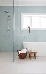 Baby Blue Herringbone Tiles In A Simple Bathroom With Wood Features Luxury Bathroom Tiles Patterned Bathroom Tiles Laundry In Bathroom