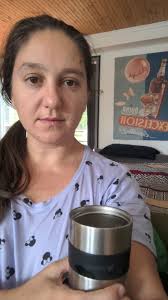 Smiling at the aroma of a hot cup of coffee