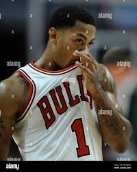 Chicago Bulls' Derrick Rose wipes his face during the first half of an NBA  preseason basketball