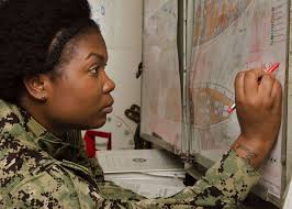 Ship's Serviceman 2nd Class Lasasha Raye, assigned to the submarine tender  USS Frank Cable (AS 40), uses a plotting diagram during a main space fire  drill aboard the ship.