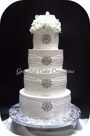 Elegant White Wedding Cake With Silver Brooches Bling Wedding Cakes Wedding Cakes Beautiful Wedding Cakes