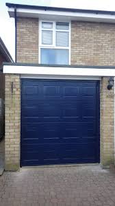 Hormann Sectional S Panelled Woodgrain Garage Door In Dark Blue Swr Redefining Homes Garage Door Styles Garage Door Design Door Gate Design