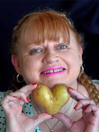 Woman is saving heart-shaped potato for Valentine's Day dinner