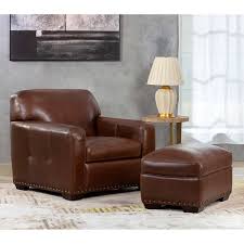 This chair is highlighted with an outer lumbar pillow that provides lower back support and a swivel seat. Winslow 2 Piece Brown Leather Chair Ottoman Set