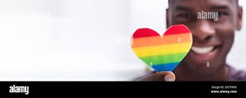Hand holding rainbow heart hi-res stock photography and images