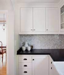 Quartz kitchen countertops kitchen countertop materials granite kitchen kitchen flooring new kitchen kitchen ideas quartz counter country two tone black and white kitchen features off white cabinets with black cup pulls and black quartz countertops lined with beadboard trim and. Colour Review Benjamin Moore Simply White Backsplash For White Cabinets Black Countertops Black Granite Countertops