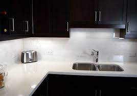 Overall, there's a lot of visual interest in this kitchen. White Quartz Countertops Pros And Cons Tags White Diamond Quartz Counterto Trendy Kitchen Backsplash Backsplash With Dark Cabinets White Quartz Countertop