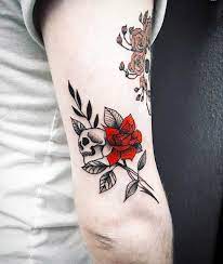 Red Rose And Skull Tattoo Inked On The Back Of The Right Upper Arm By Bek Tattoos Floral Skull Tattoos Red Ink Tattoos