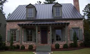 The house viewed from the passing street. Black Metal Roof