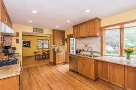 This kitchen offers yellow and glass front cabinets along with a small island that's topped with a wooden counter. 75 Beautiful Yellow Kitchen With Brown Cabinets Pictures Ideas June 2021 Houzz