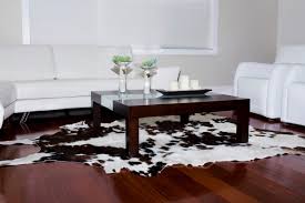 The black and white cowhide rug placed underneath the coffee table is the only piece that creates such a strong contrast of colors. Using Faux Sheepskin And Cowhide Rugs In Your Home
