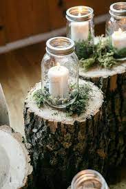 Love These Rustic Wood Stumps With Moss And Mason Jar Candle Holders For Woodland Rustic Wedding Mason Jar Wedding Mason Jar Candles Wedding Ideas Small Budget
