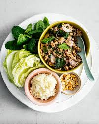 In a large bowl, whisk together shallots, fish sauce, lime juice, sugar, bird's eye chile, chile flakes, half the scallions, half the mint and half the cilantro. Larb Moo Pork Larb Recipe Thai Pork Salad I Am A Food Blog Recipe Pork Salad Larb Recipe Pork Larb