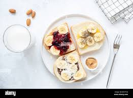 Vegan Or Vegetarian Bread Nut Butter Jam And Chia Seed Toast Healthy Breakfast Healthy Lunch Toast With Nut Butter And Banana Flat Lay Healthy Stock Photo Alamy