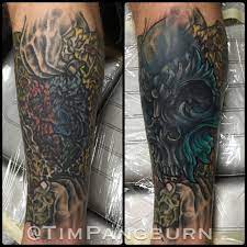 Brilliantly covered cross tattoo behind the neck. Timpangburn Demon Skull Cover Up Cover Up Cover Up Tattoo Coverup Coverup Tattoo Skull Skull Tattoo New School New School Tattoo Tim Pangburn Art Machine Art Machine Productions