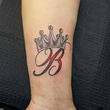 A beautiful and cheeky tattoo. B Letter With Crown Tattoo On Wrist Crown Tattoo On Wrist Letter B Tattoo Crown Hand Tattoo