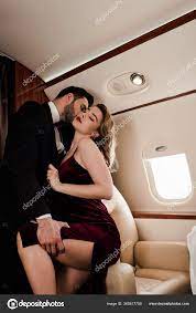 Elegant Man Touching Leg Kissing Passionate Woman Plane Stock Photo by  ©HayDmitriy 360817750
