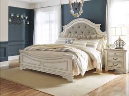 The ralene queen upholstered bed with bench storage footboard by signature design by ashley at. Realyn Chipped Two Tone King Upholstered Panel Bed 1stopbedrooms