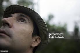 Bird counter Rafael Antonio Galvez holds his binoculars as he tries... News  Photo