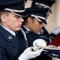 Chief Information Specialist Technician Dwayne Peterson fits a combination  cover