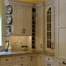 The cream cabinets and drawers for this kitchen complement well with the tuba granite used for the countertops; Photos Hgtv