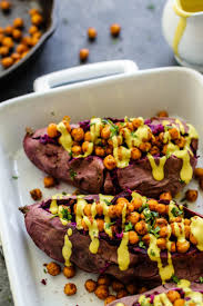 Stuffed Purple Sweet Potatoes With Tandoori Chickpeas Turmeric Tahini Japanese Sweet Potato Purple Sweet Potatoes Sweet Potato Recipes