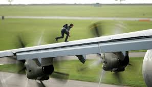 Hunt sprints onto the plane's wing and ends up clinging onto the outer door. Mission Impossible Rogue Nation Plugged In