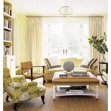 Creamy Yellow Walls And Sofa Cream Curtains Black White And Green Graphics On Sea Grass Rug Yellow Living Room Small Apartment Decorating Home Decor