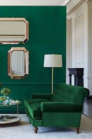 Dark green accent walls are a popular choice for a dramatic moody vibe. Trend We Love 10 Emerald Interior Ideas Domino Living Room Green Home Decor Living Room Designs