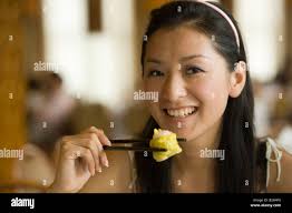 Woman eating dim sum hi-res stock photography and images
