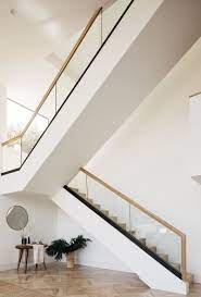 High Ceilings And Double Height Windows Keep This L A House Bright And Airy Glass Railing Stairs Woods Glass Railing Stairs Stairs