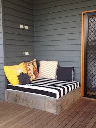 Hanging outdoor daybed with multicolored quilt. Amanda Flory Ammaconda Profile Pinterest