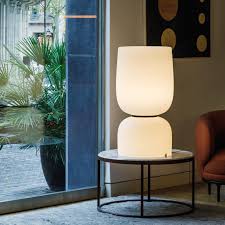 A coffee table is a low table designed to be placed in a sitting area for convenient support of beverages, remote controls, magazines, books (especially large, illustrated coffee table books), decorative objects, and other small items. Vibia Table Lamps