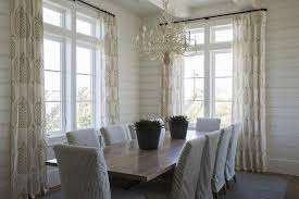 Gray Pinstripe Dining Chairs Surround A Walnut Stained Dining Table Lit By A Sea Coral Chandelie Cottage Dining Rooms Dining Chair Slipcovers Blue Dining Chair