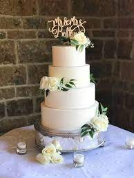 An Minimalist Four Tier Wedding Cake Covered In Swiss Meringue Buttercream And Fresh Flowers The Go Simple Wedding Cake Buttercream Wedding Cake Wedding Cakes