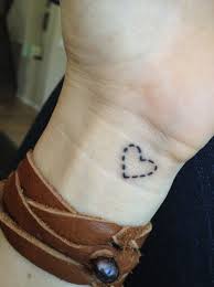 Designs such as a heart pierced with arrows expressive deep feelings of love and several elements can be incorporated with the tattoos for a richer expression. Stitched Heart Tattoo On Wrist Tattoos At Repinned Net