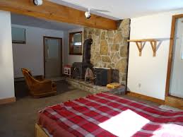This week garen & ellie plunge into another furniture project with a pallet chest, bree grabs some paint for the wood stove in her earthbag bedroom, bryson &. Lower Level Family Room Or Master Bedroom With Wood Stove And Stone Hearth Davies Davies Associates Real Estate L L C