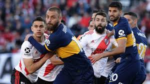 A supporter of boca, or river. From Carlos Tevez S Chicken Dance To The Bernabeu Final Why River Boca Superclasico Is Football S Fiercest Fixture Goal Com
