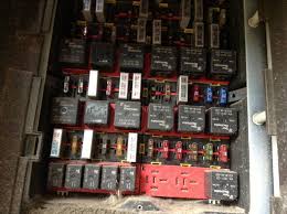 The fuses and relays are grouped on a single base positioned under the storage compartment and can be reached after opening the door (1) and removing the container (2). Kenworth Fuse Box Location