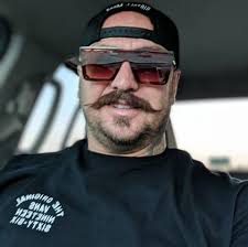 Does the Bassani system require a bent shift linkage and relocated coil  like the Samson system?