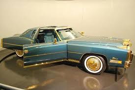 Abundance affluence american car asset belonging big car bling blue car bounty cache cadillac eldorado cherished car class classic car copiousness cornucopia custom car expensive car fortune gold gold plated gold wheels green isaac hayes lap long long car. Isaac Hayes Cadillac