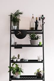 This gilded wall shelf with rounded edges and a staggered shelf design is a stylish statement maker for any room in your home. Designer Round Black Shelf Clock With Gold Hands Minimalist Shelves Black Shelf Decor Shelf Decor