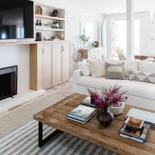 Reclaimed wood is arranged in a striking herringbone pattern on this coffee table. Reclaimed Wood And Metal Coffee Table On Gray Stripe Rug Cottage Living Room