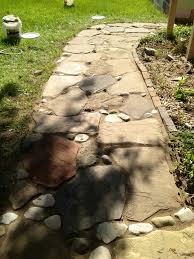 We need some advice on laying a flagstone patio. Stone Walk Way With River Rock And Polymer Sand To Fill In The Joints Diy Landscaping Stone Pathway Outdoor Life